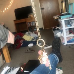 Long gold necklace with light pink accents
